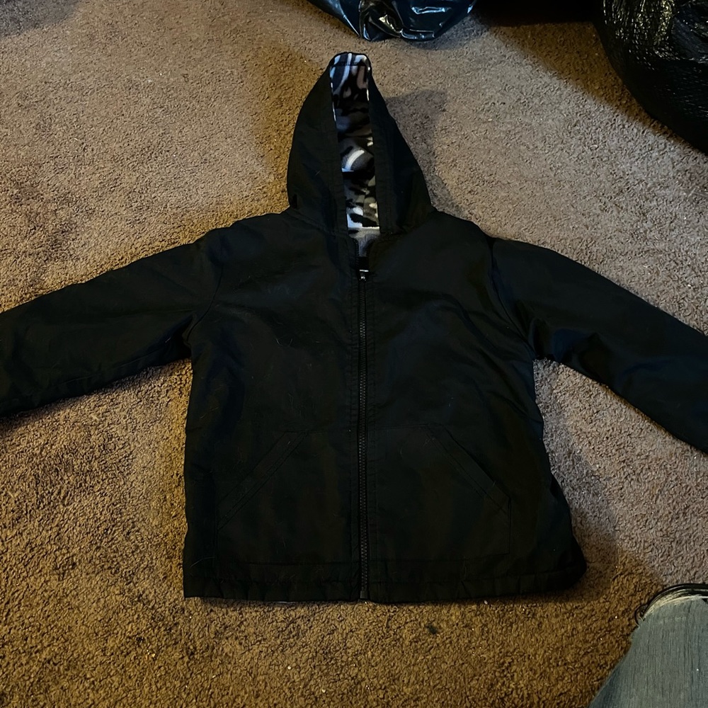 Black on the outside black grey and white camp fleece on the inside zip up